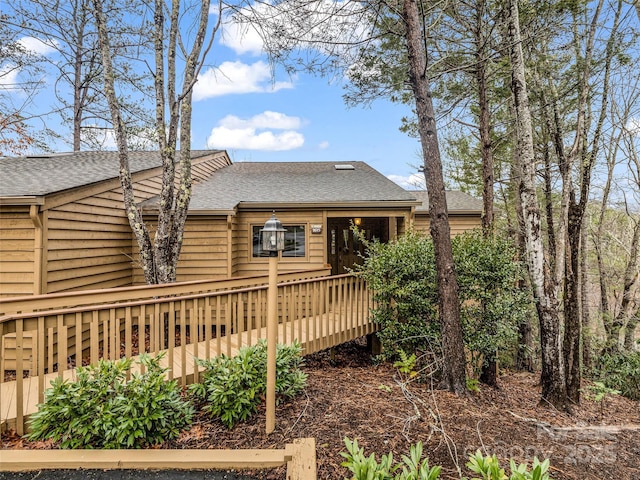 rear view of property with a wooden deck