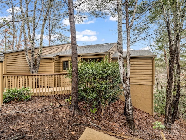 view of side of property featuring a wooden deck