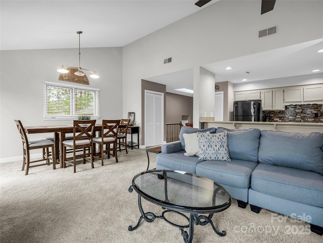 living room featuring light carpet and high vaulted ceiling