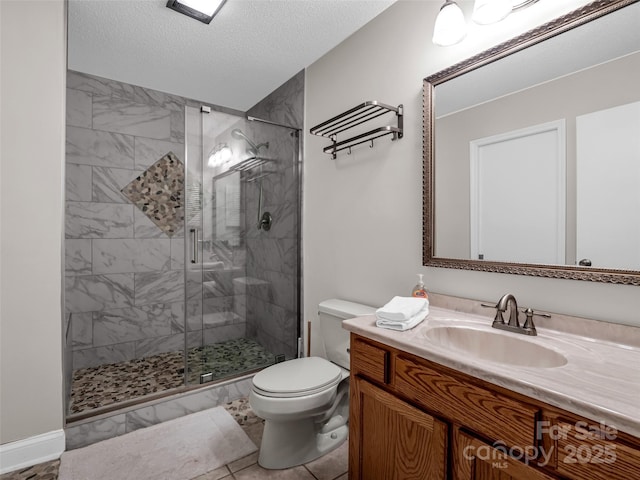 bathroom featuring a textured ceiling, vanity, an enclosed shower, and toilet