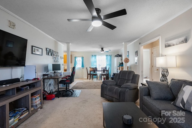 carpeted living room with a textured ceiling, ceiling fan, and crown molding