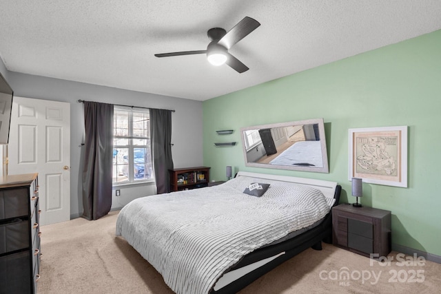 carpeted bedroom with a textured ceiling and ceiling fan