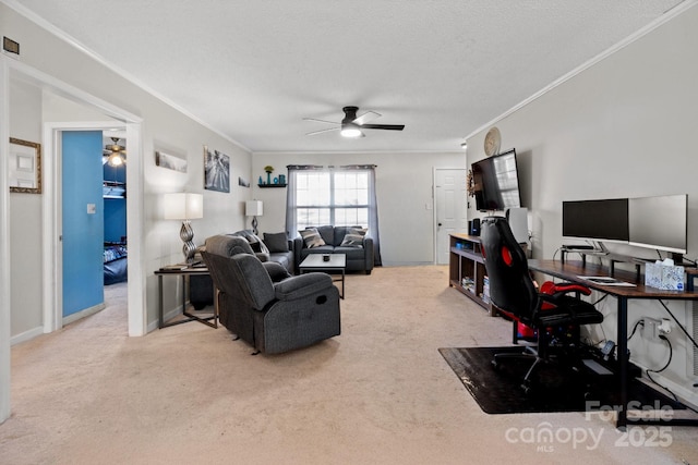 office area with a textured ceiling, ceiling fan, crown molding, and light carpet