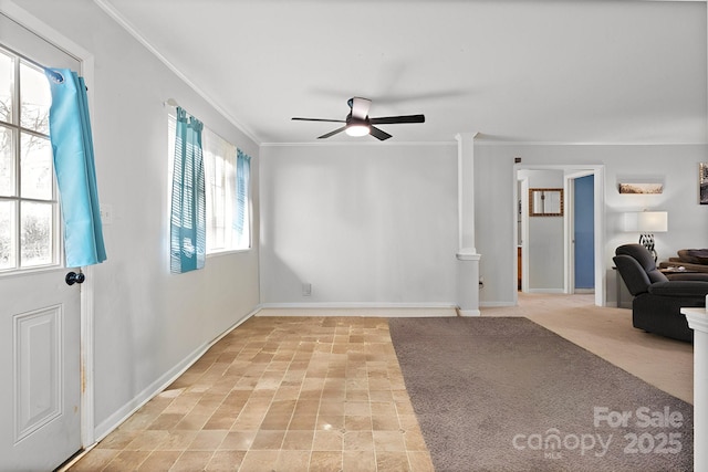 interior space with ceiling fan, crown molding, and light colored carpet