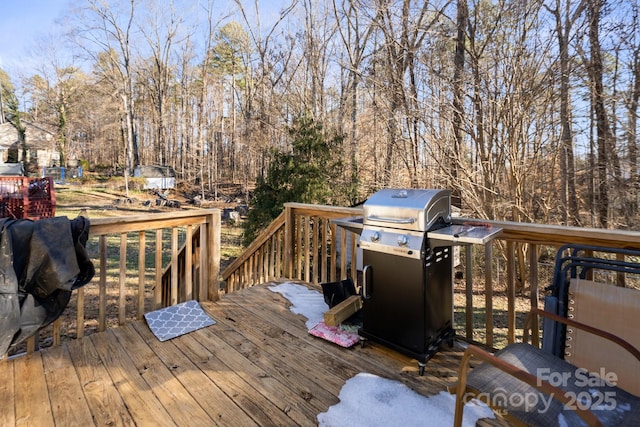 wooden terrace featuring a grill