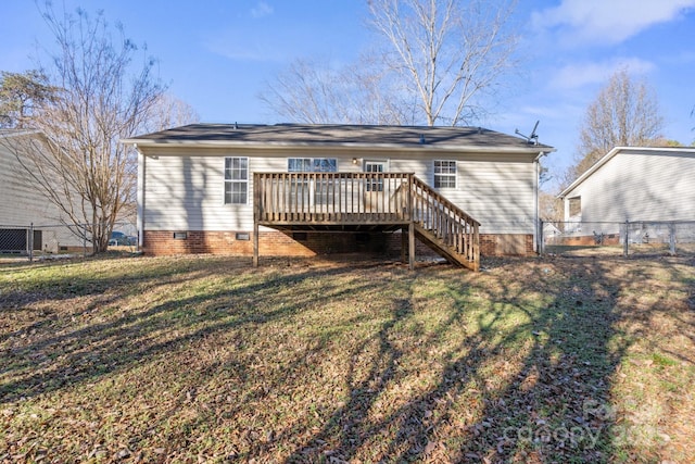 rear view of house with a deck and a yard