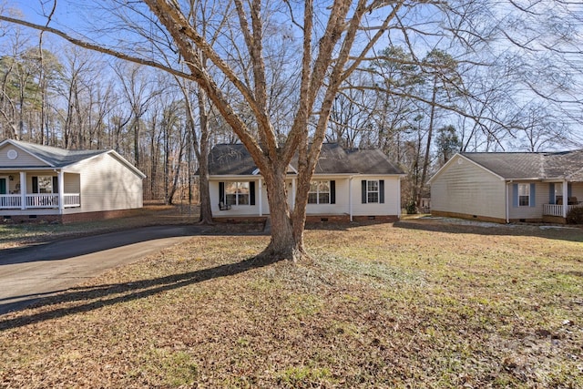 ranch-style house featuring a front yard and covered porch