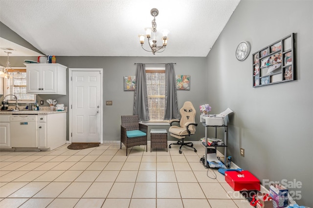 dining space featuring vaulted ceiling, a wealth of natural light, a notable chandelier, and sink