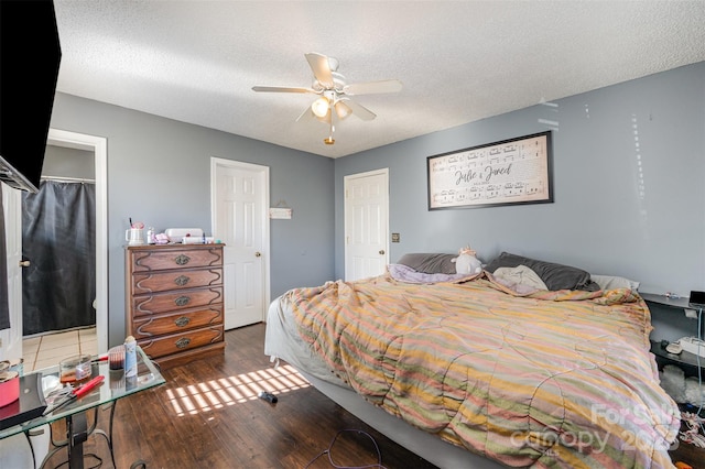 bedroom featuring ceiling fan, dark hardwood / wood-style floors, a textured ceiling, and a closet