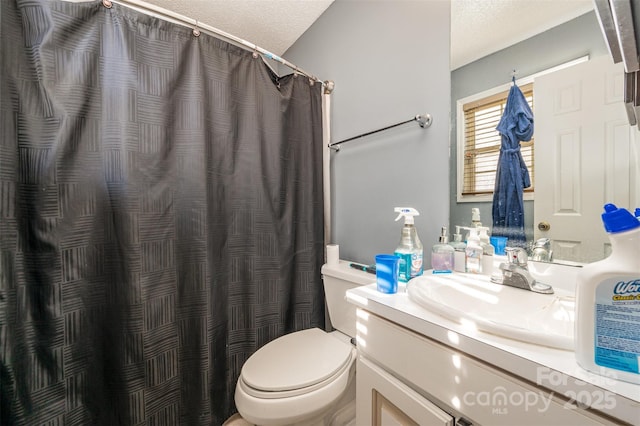 bathroom featuring vanity, toilet, and a textured ceiling