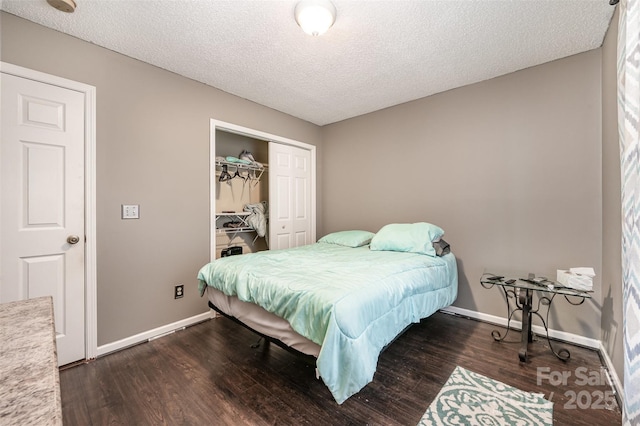 bedroom featuring a textured ceiling, a closet, and dark wood-type flooring