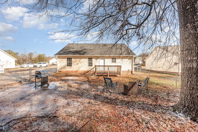 rear view of house featuring a wooden deck