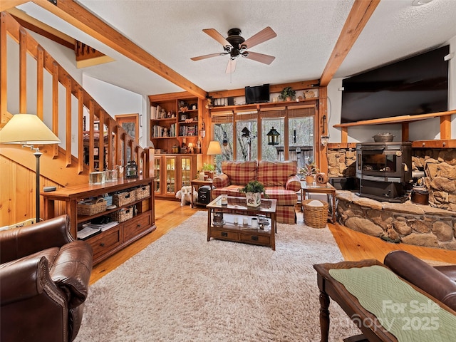 41 Cottontail Ln, Canton, NC 28716 - living room with beam ceiling, a ceiling fan, wood finished floors, stairs, and a textured ceiling