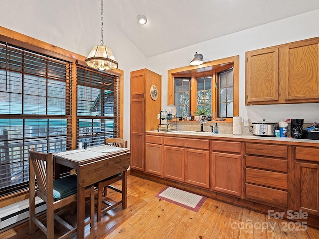 41 Cottontail Ln, Canton, NC 28716 - kitchen with lofted ceiling, a chandelier, light countertops, and brown cabinetry