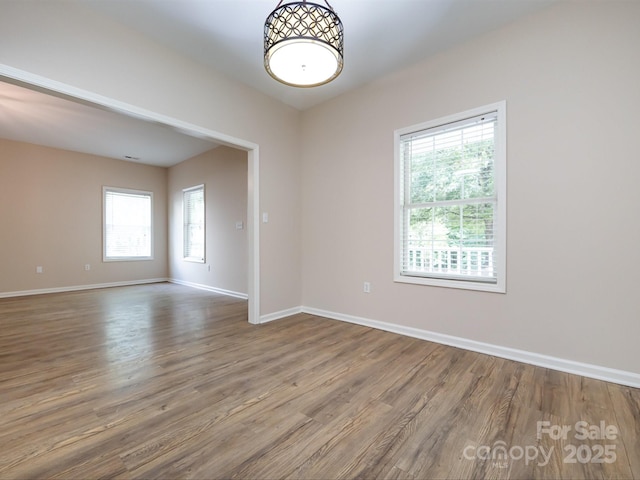 empty room with hardwood / wood-style floors