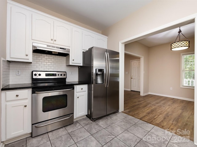 kitchen featuring decorative light fixtures, backsplash, stainless steel appliances, and white cabinetry