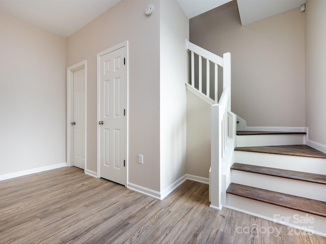 stairs with hardwood / wood-style floors