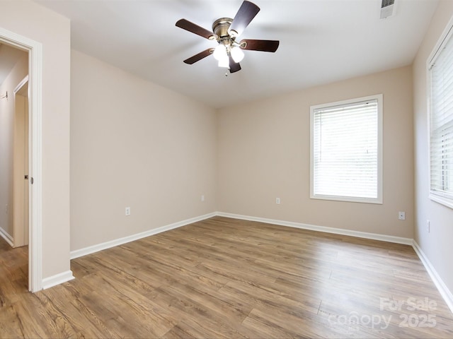 empty room featuring ceiling fan and light hardwood / wood-style flooring