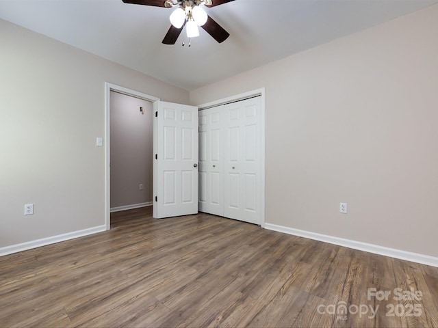 unfurnished bedroom with hardwood / wood-style flooring, ceiling fan, and a closet