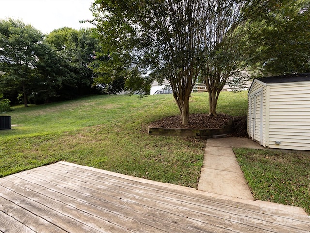 view of yard featuring a wooden deck and a shed