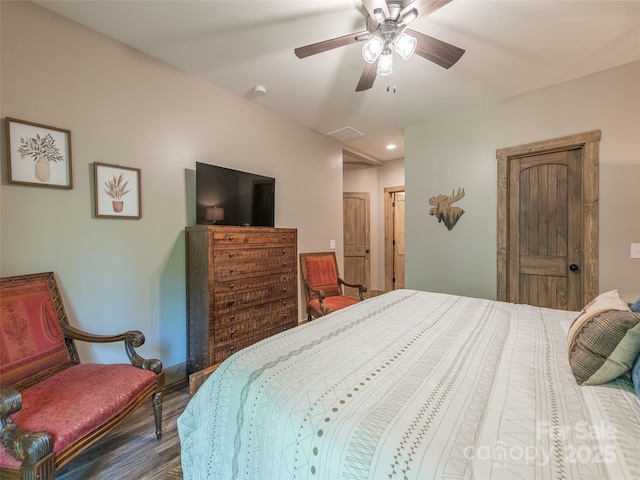 bedroom featuring ceiling fan and dark wood-type flooring