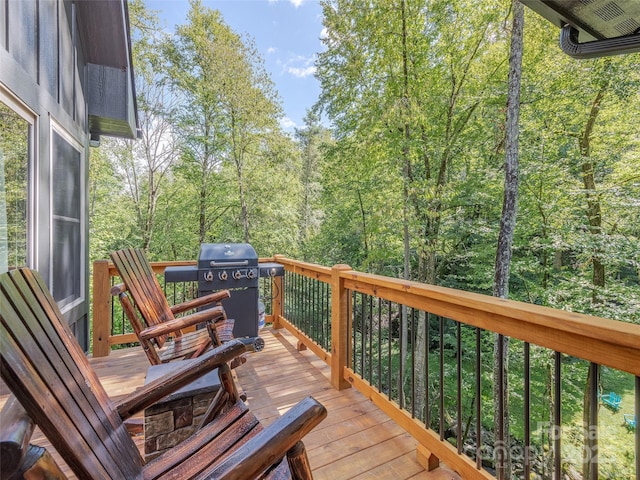 wooden terrace featuring a grill