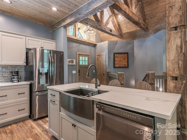 kitchen with beam ceiling, sink, wood ceiling, and appliances with stainless steel finishes