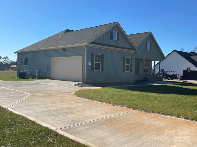 exterior space featuring central AC unit, a garage, and a front lawn