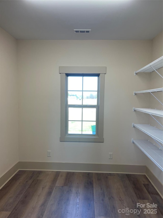 empty room with dark hardwood / wood-style floors