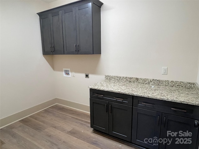 laundry room with washer hookup, electric dryer hookup, cabinets, and light wood-type flooring