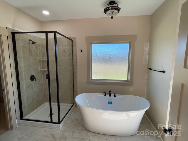 bathroom with separate shower and tub