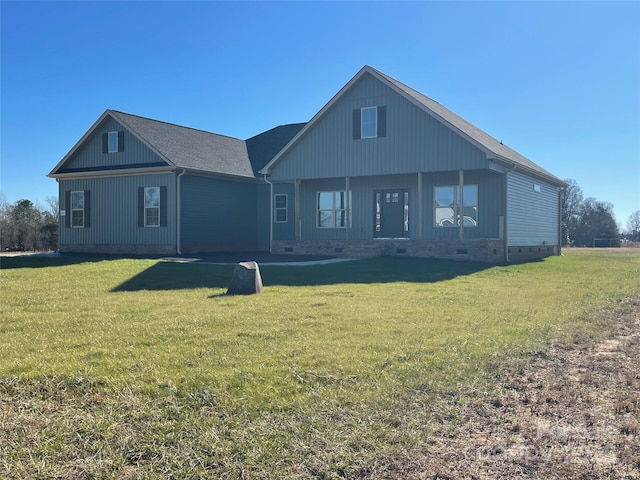 rear view of property with a lawn