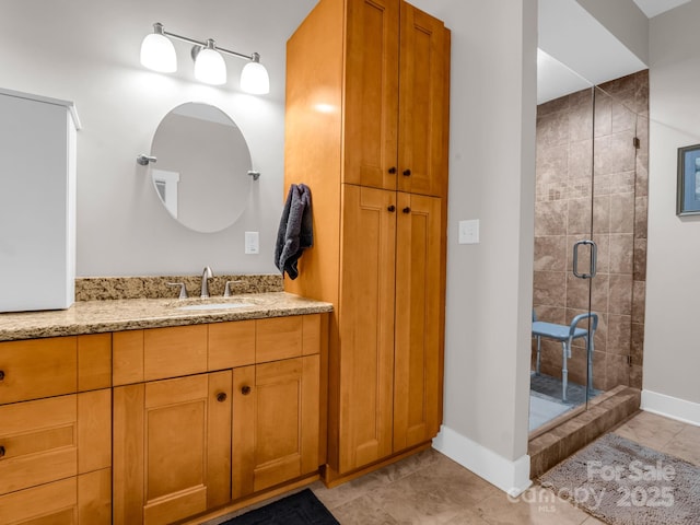 bathroom with a shower with door, vanity, and tile patterned flooring