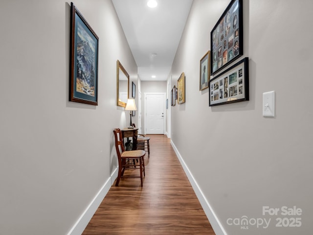 hallway with dark hardwood / wood-style floors