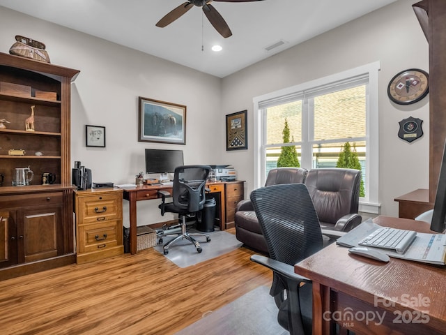 office with light hardwood / wood-style floors and ceiling fan