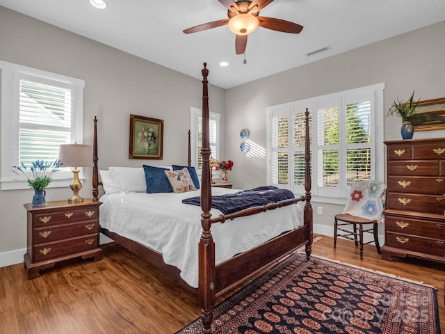 bedroom with ceiling fan and wood-type flooring