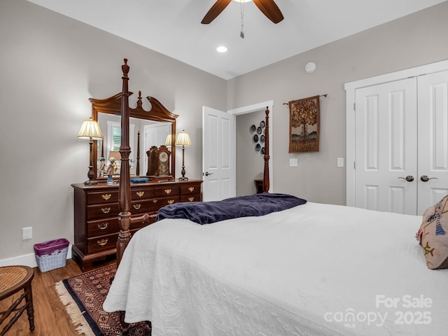 bedroom featuring ceiling fan, a closet, and wood-type flooring