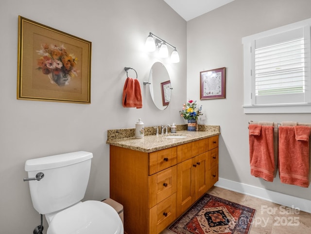 bathroom featuring tile patterned flooring, vanity, and toilet