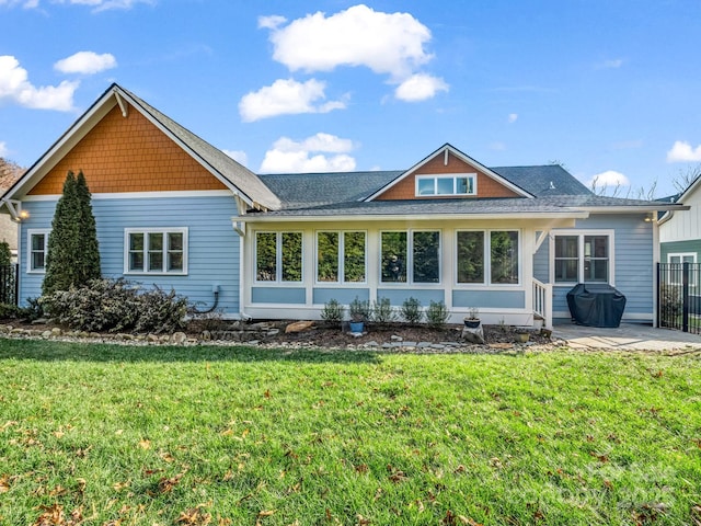 back of property with a patio area and a lawn