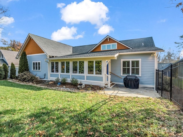 back of house featuring a yard and a patio