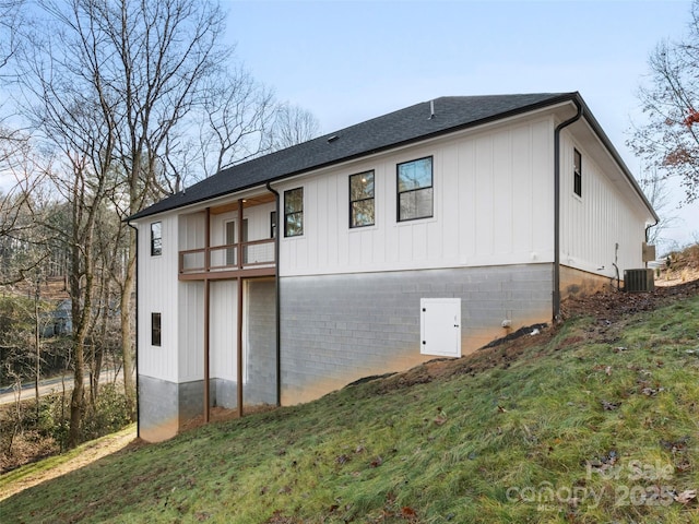 view of home's exterior featuring a yard, a balcony, and cooling unit