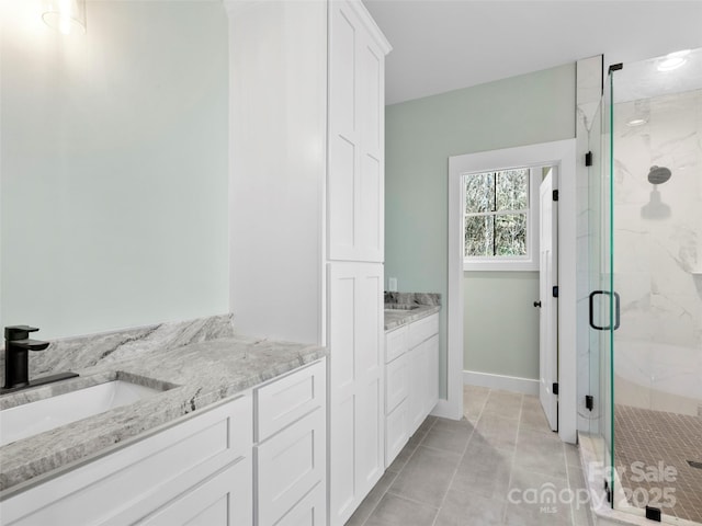 bathroom with vanity, tile patterned floors, and a shower with door