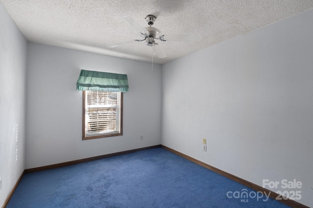 carpeted empty room featuring a textured ceiling and ceiling fan