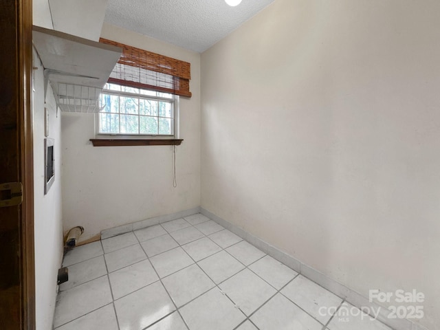 spare room featuring a textured ceiling