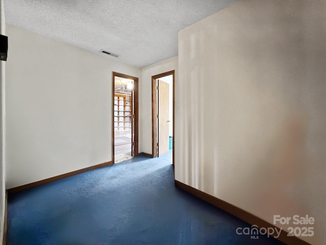 empty room with a textured ceiling