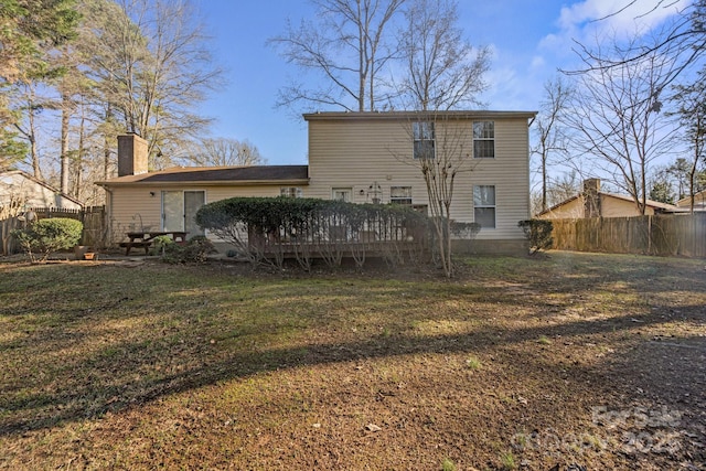 rear view of property featuring a deck and a yard