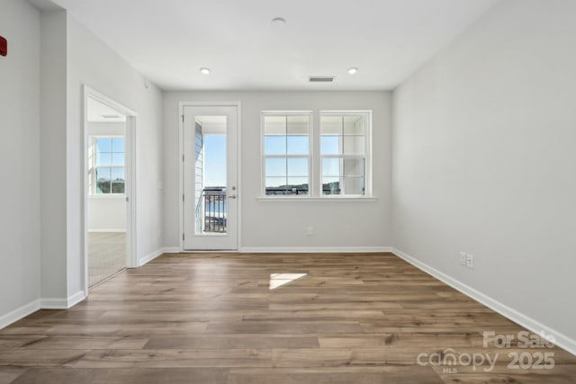 spare room with hardwood / wood-style floors