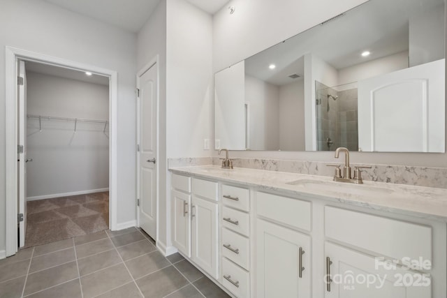 bathroom featuring walk in shower, tile patterned floors, and vanity