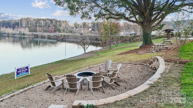 view of yard featuring a fire pit and a water view