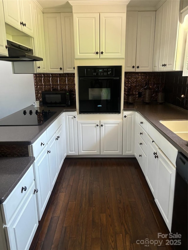 kitchen featuring decorative backsplash, white cabinetry, dark wood-type flooring, and black appliances